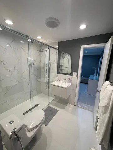 a bathroom with a sink toilet and shower