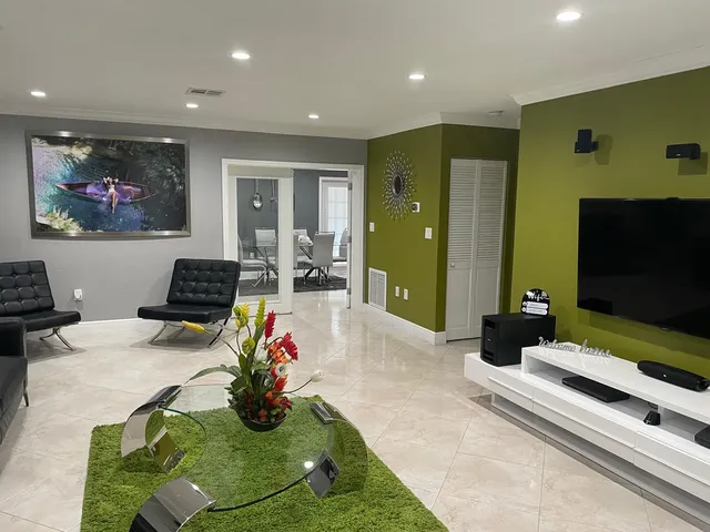 a living room with furniture and a flat screen tv
