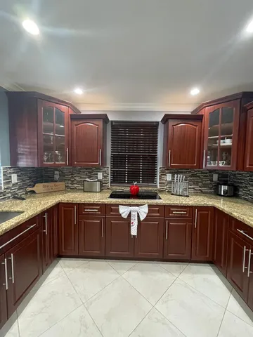 a large kitchen with wooden cabinets