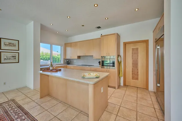 a dining room with furniture and a floor to ceiling window