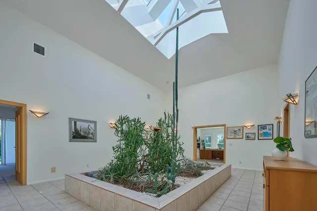 a room with lots of potted plants