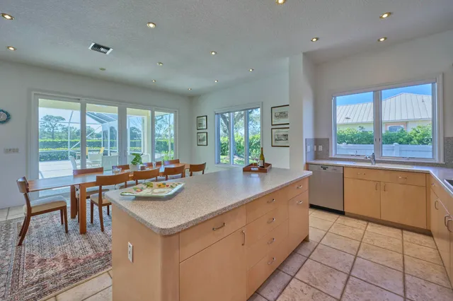 a kitchen with stainless steel appliances granite countertop a sink and a refrigerator