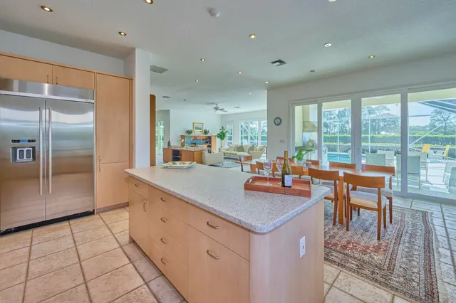 a kitchen with stainless steel appliances granite countertop a refrigerator and a stove
