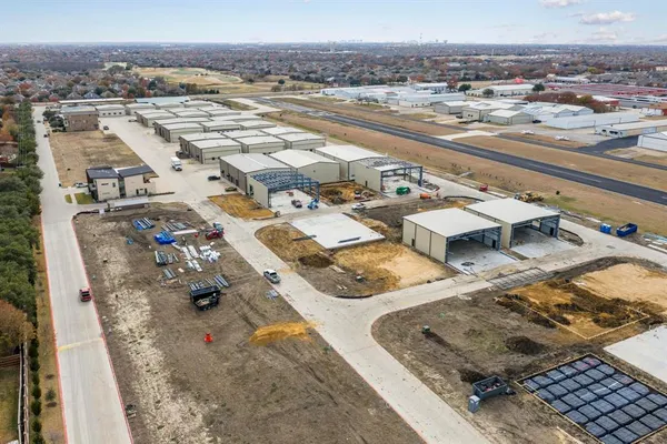an aerial view of beach and front of residential building