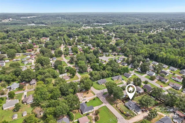 an aerial view of a house with a yard
