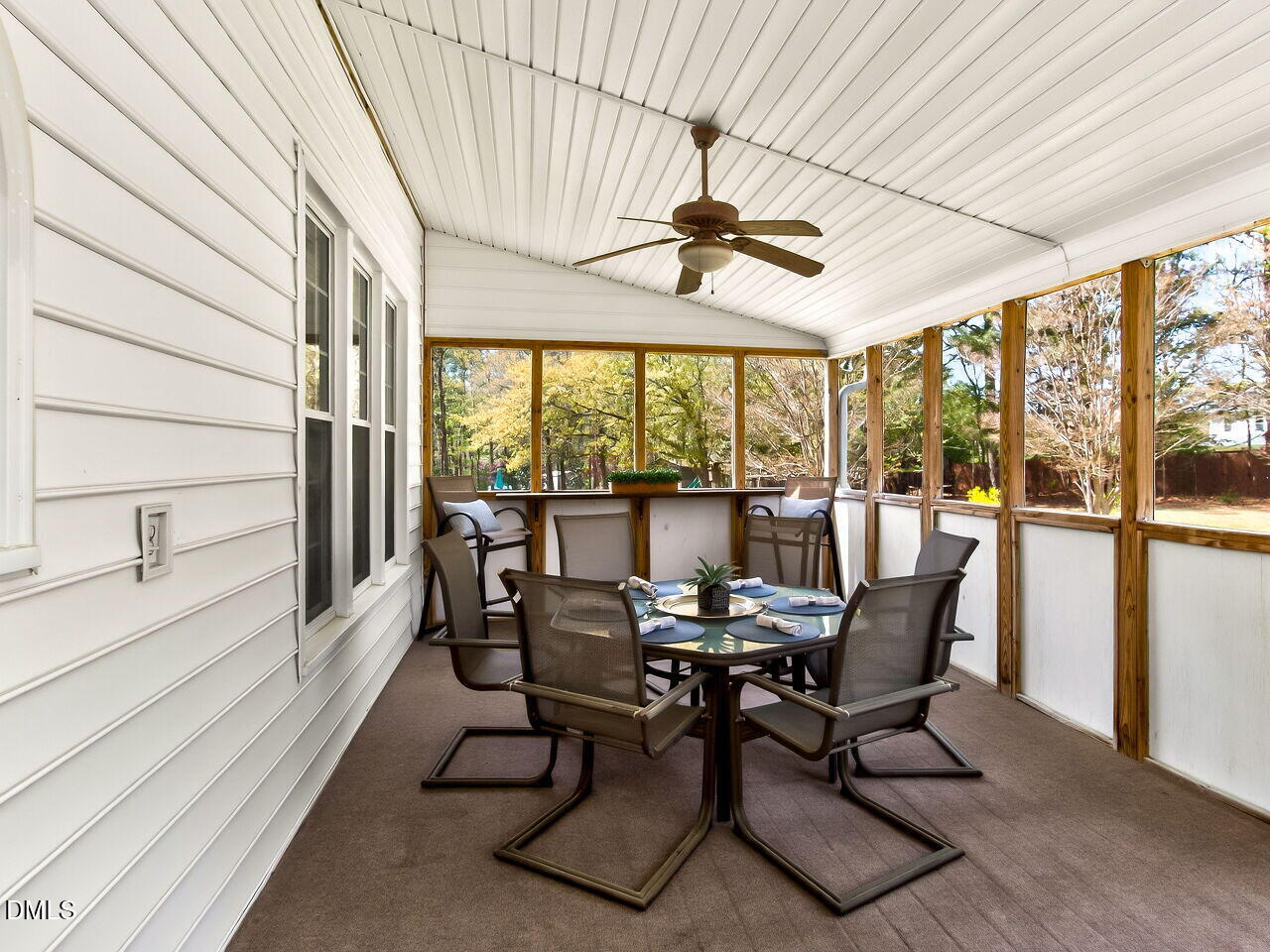 6104 Wolverhampton Drive Raleigh, NC 27603 - Photo 13 of 35 a view of a dining room with furniture large windows and wooden floor