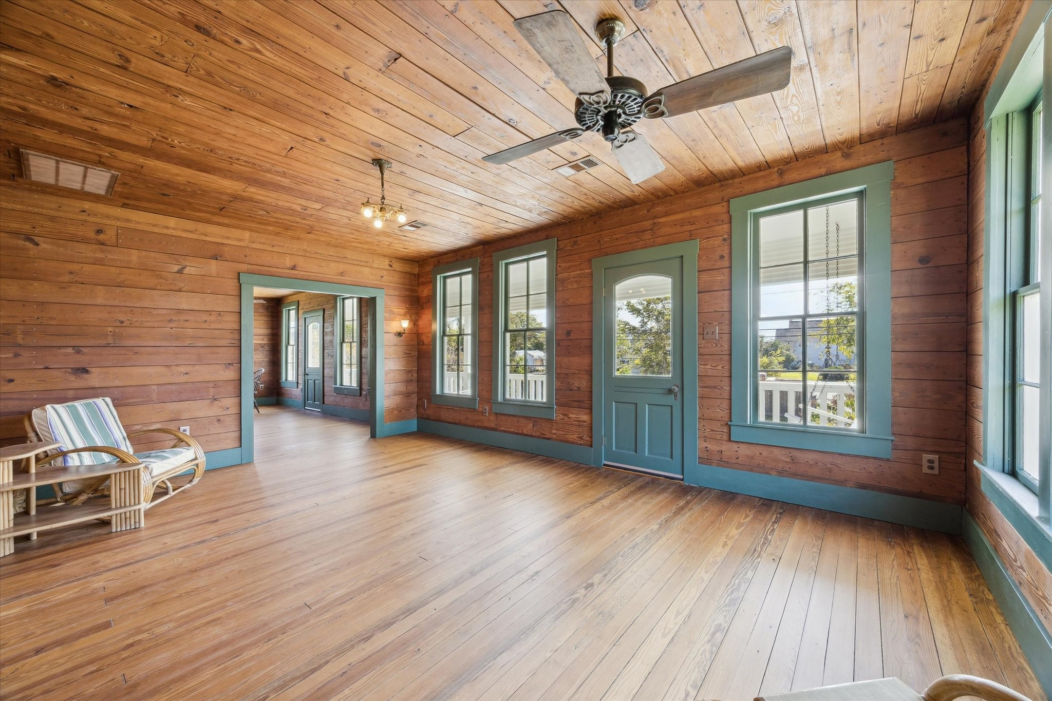 618 Bayridge Road La Porte, TX 77571 - Photo 11 of 40 THE SPACIOUS DEN FEATURES WOOD FLOORS, WOOD PLANK WALLS AND CEILINGS AND ACCESS TO THE BALCONY OVERLOOKING THE BAY.