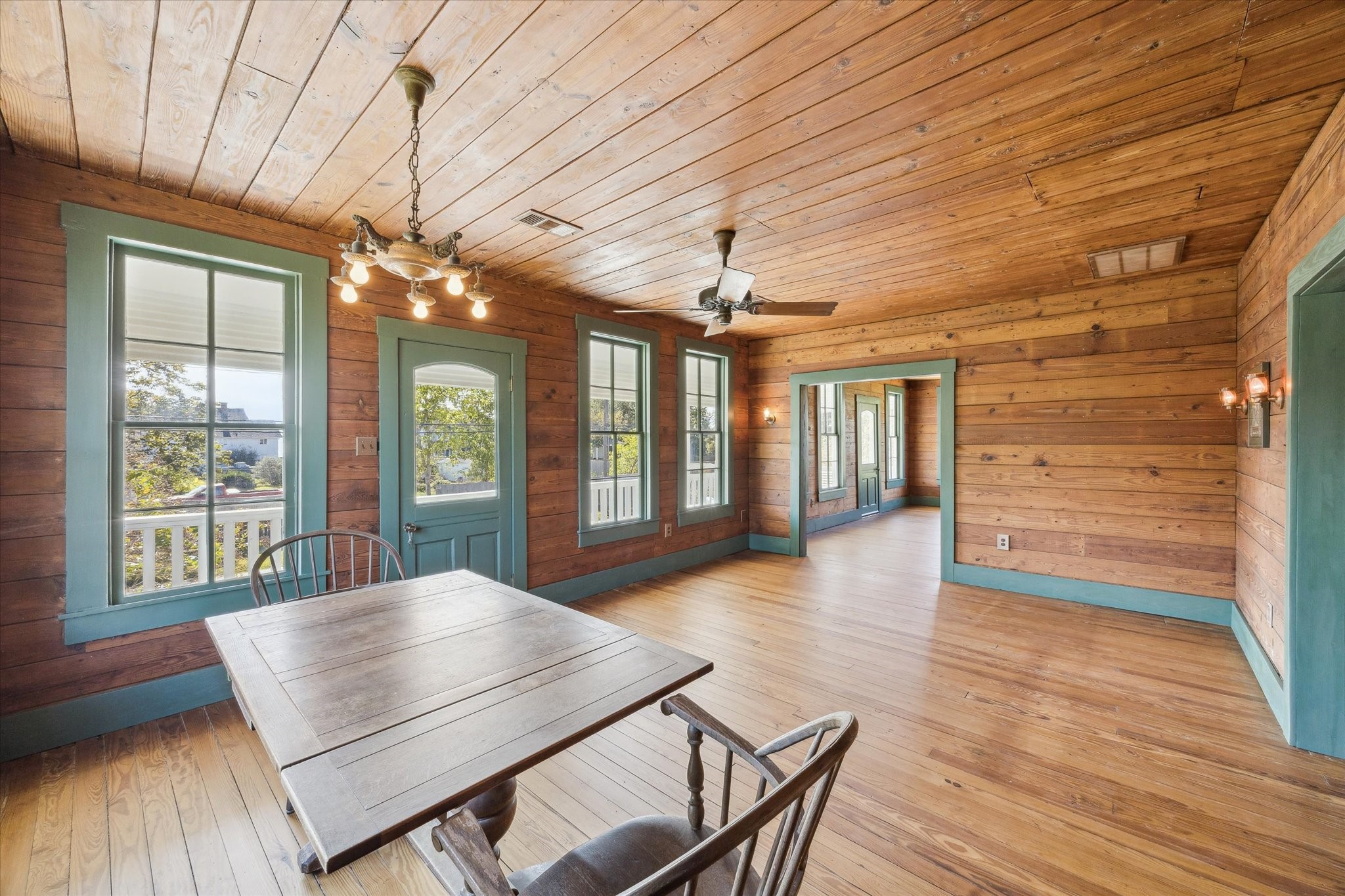 618 Bayridge Road La Porte, TX 77571 - Photo 13 of 40 CONNECTED TO THE DEN IS THE SPACIOUS DINING ROOM, FEATURING WOOD FLOORS, WOOD PLANK WALLS AND CEILINGS AND ACCESS TO THE BALCONY OVERLOOKING THE BAY.