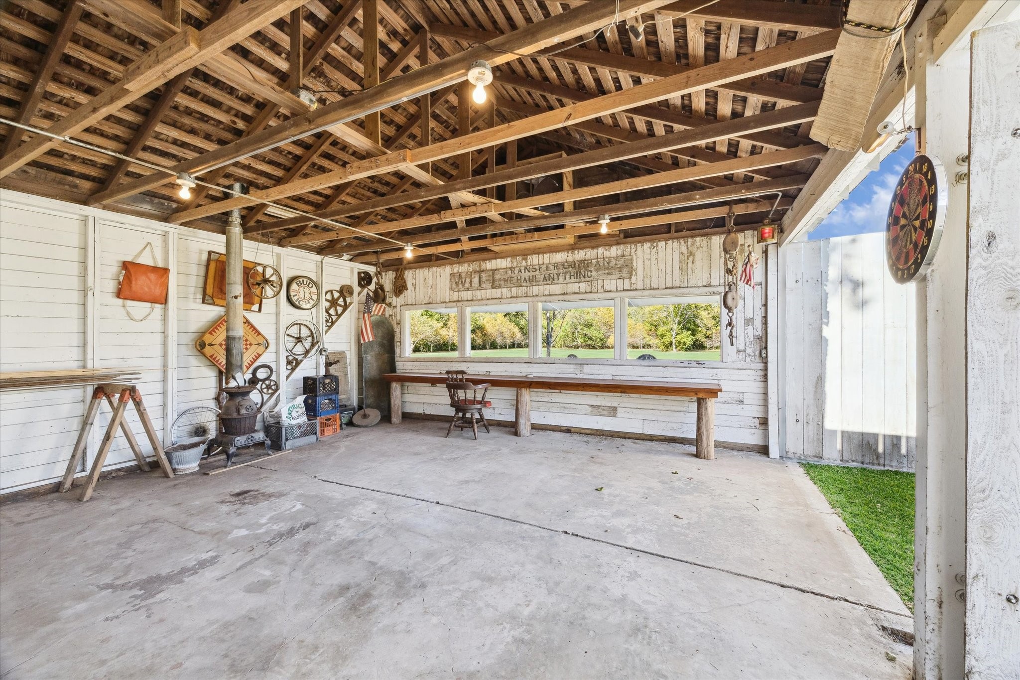 618 Bayridge Road La Porte, TX 77571 - Photo 30 of 40 THE BARN IS ALSO HEATED WITH AN OLD STOVE, A BAR AND SHUTTERS THAN RAISE TO OVERLOOK THE PRIVATE BACKYARD.