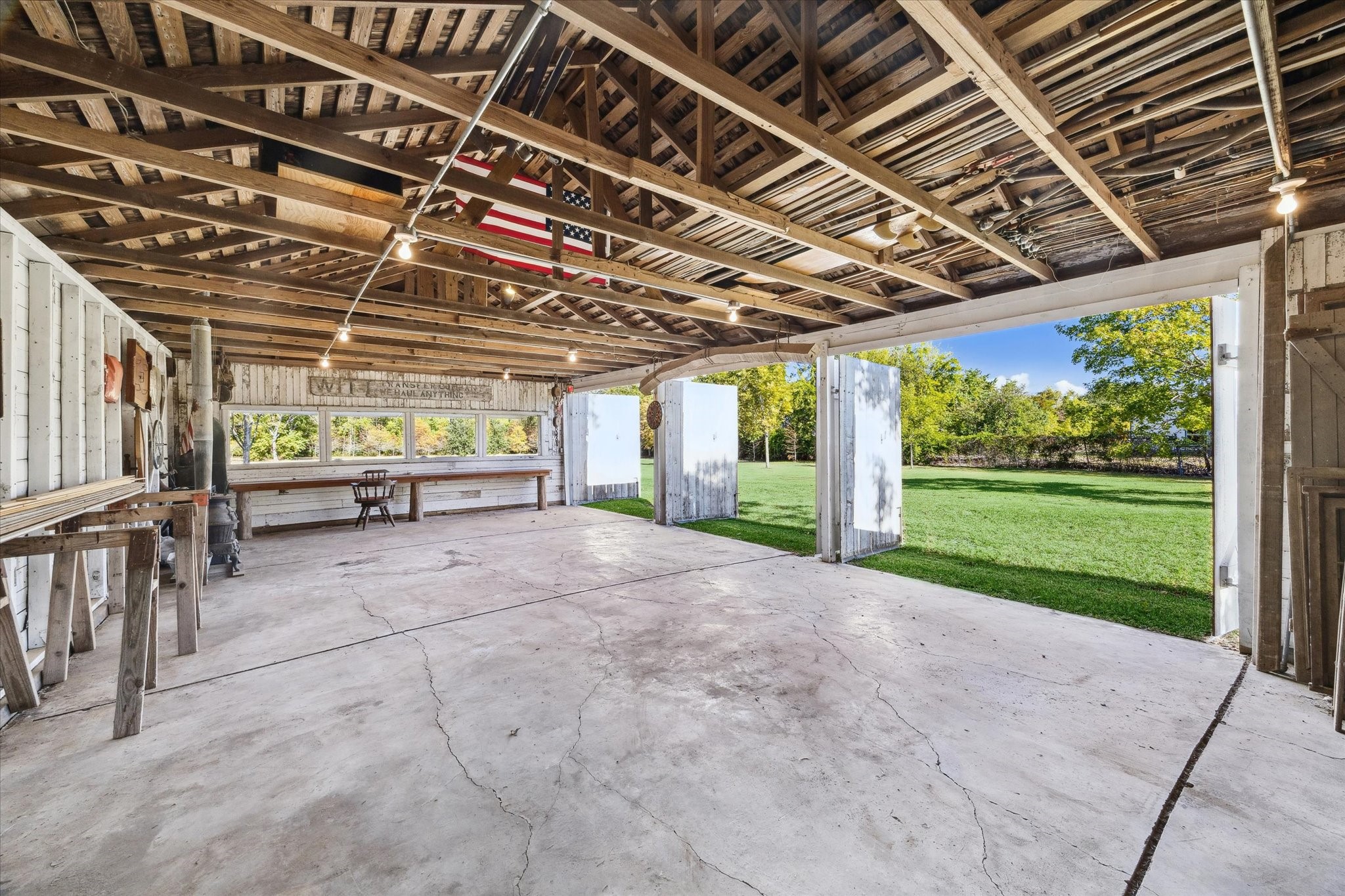 618 Bayridge Road La Porte, TX 77571 - Photo 6 of 40 BEHIND THE HOUSE IS A DETACHED GARAGE/BARN FEATURING PARKING FOR 3 VEHICLES, A WORKSHOP AREA AND A GREENHOUSE.