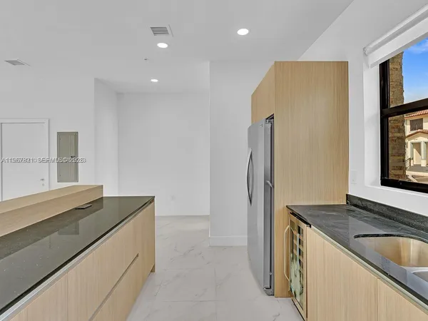 a kitchen with a sink and a refrigerator