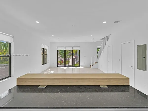 a room with pool table and windows