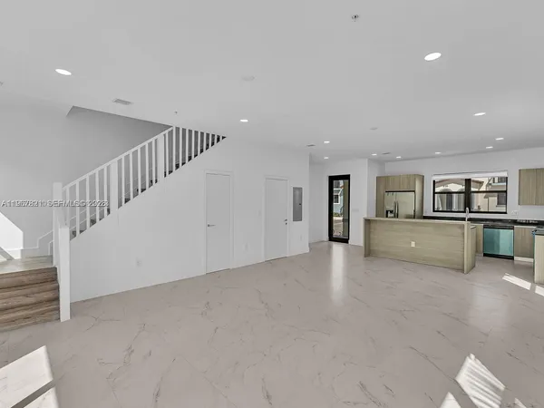 a view of a kitchen with a sink and dishwasher