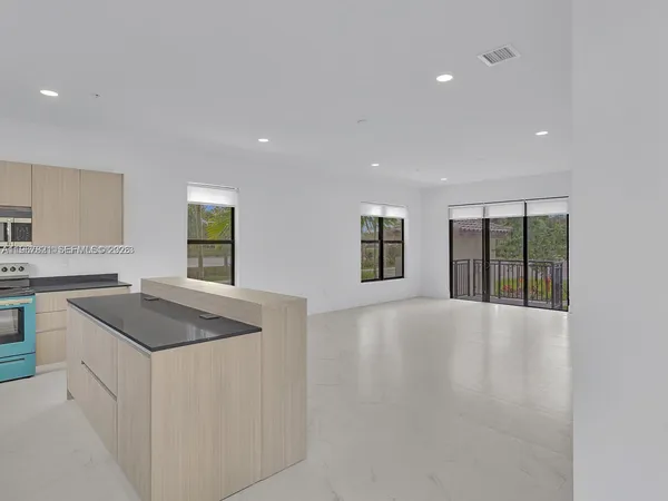 a kitchen with stainless steel appliances granite countertop a sink and a granite counter tops