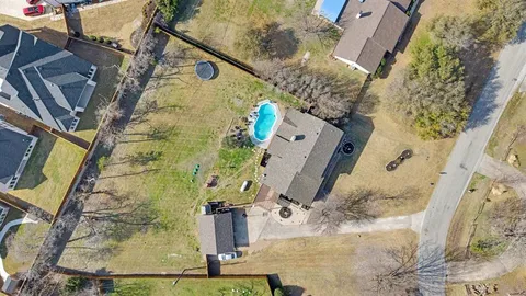 an aerial view of residential house with outdoor space and parking