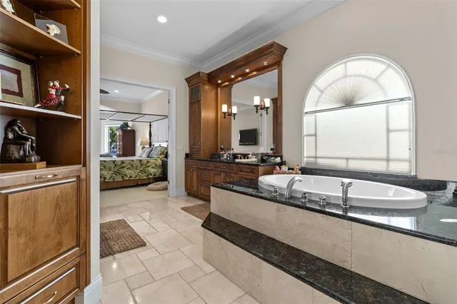 a living room with furniture a flat screen tv and kitchen view