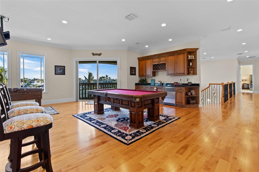 7986 9th Avenue South St. Petersburg, FL 33707 - Photo 36 of 83 a living room with furniture a flat screen tv and kitchen view