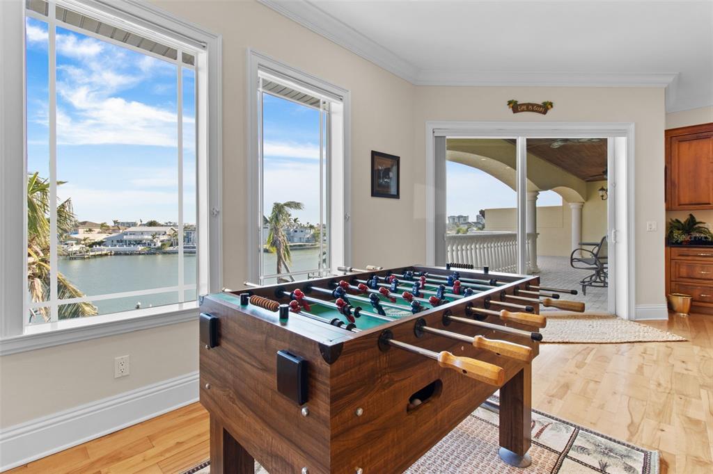 7986 9th Avenue South St. Petersburg, FL 33707 - Photo 37 of 83 a living room with chairs pool table and a large window