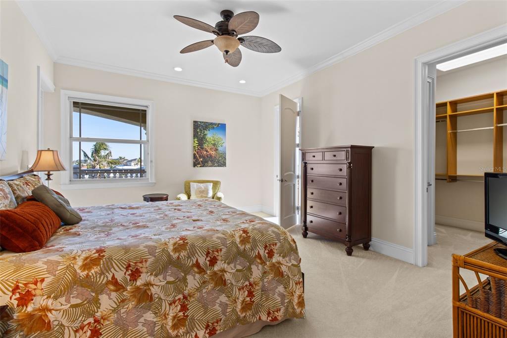 7986 9th Avenue South St. Petersburg, FL 33707 - Photo 49 of 83 a bedroom with a bed and a flat tv screen on dresser