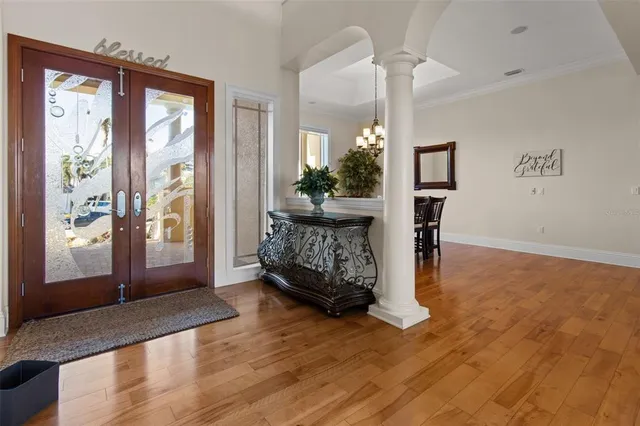 a view of a dining room with furniture wooden floor and chandelier