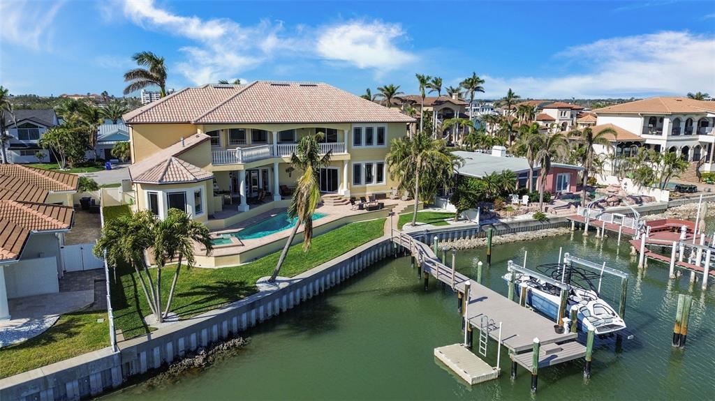7986 9th Avenue South St. Petersburg, FL 33707 - Photo 63 of 83 an aerial view of a house with swimming pool a patio and lake view