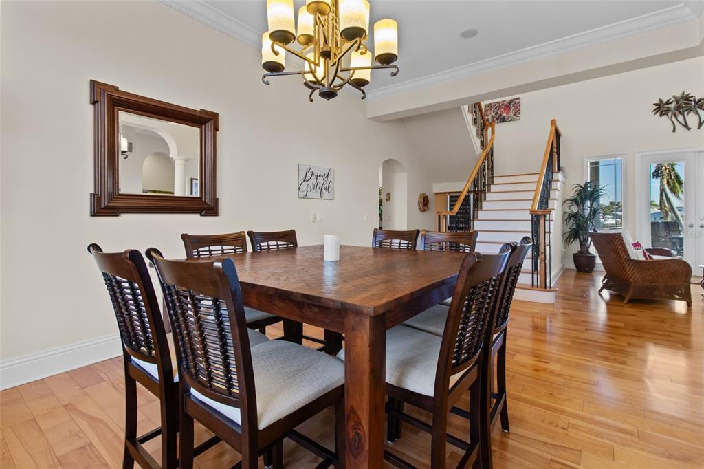 7986 9th Avenue South St. Petersburg, FL 33707 - Photo 8 of 83 a view of a dining room with furniture wooden floor and chandelier