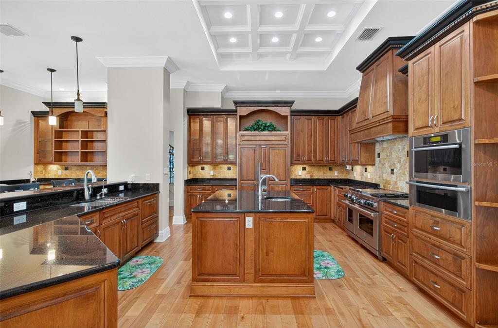 7986 9th Avenue South St. Petersburg, FL 33707 - Photo 9 of 83 a kitchen with stainless steel appliances granite countertop a stove a sink and a refrigerator