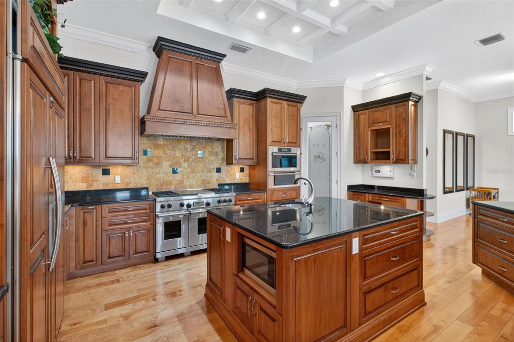 7986 9th Avenue South St. Petersburg, FL 33707 - Photo 10 of 83 a kitchen with stainless steel appliances granite countertop a stove top oven a sink a counter space and cabinets