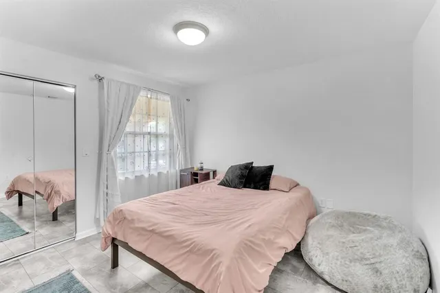 an aerial view of a city with lots of residential buildings lake and ocean view