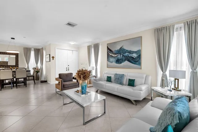 a view of a dining room with furniture and a large window