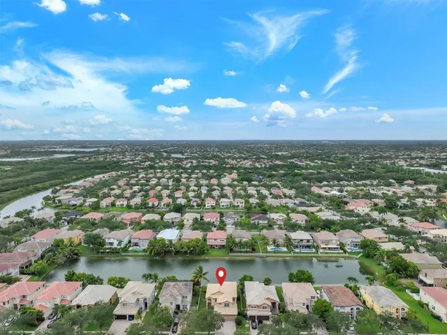 an aerial view of residential houses with outdoor space and lake view
