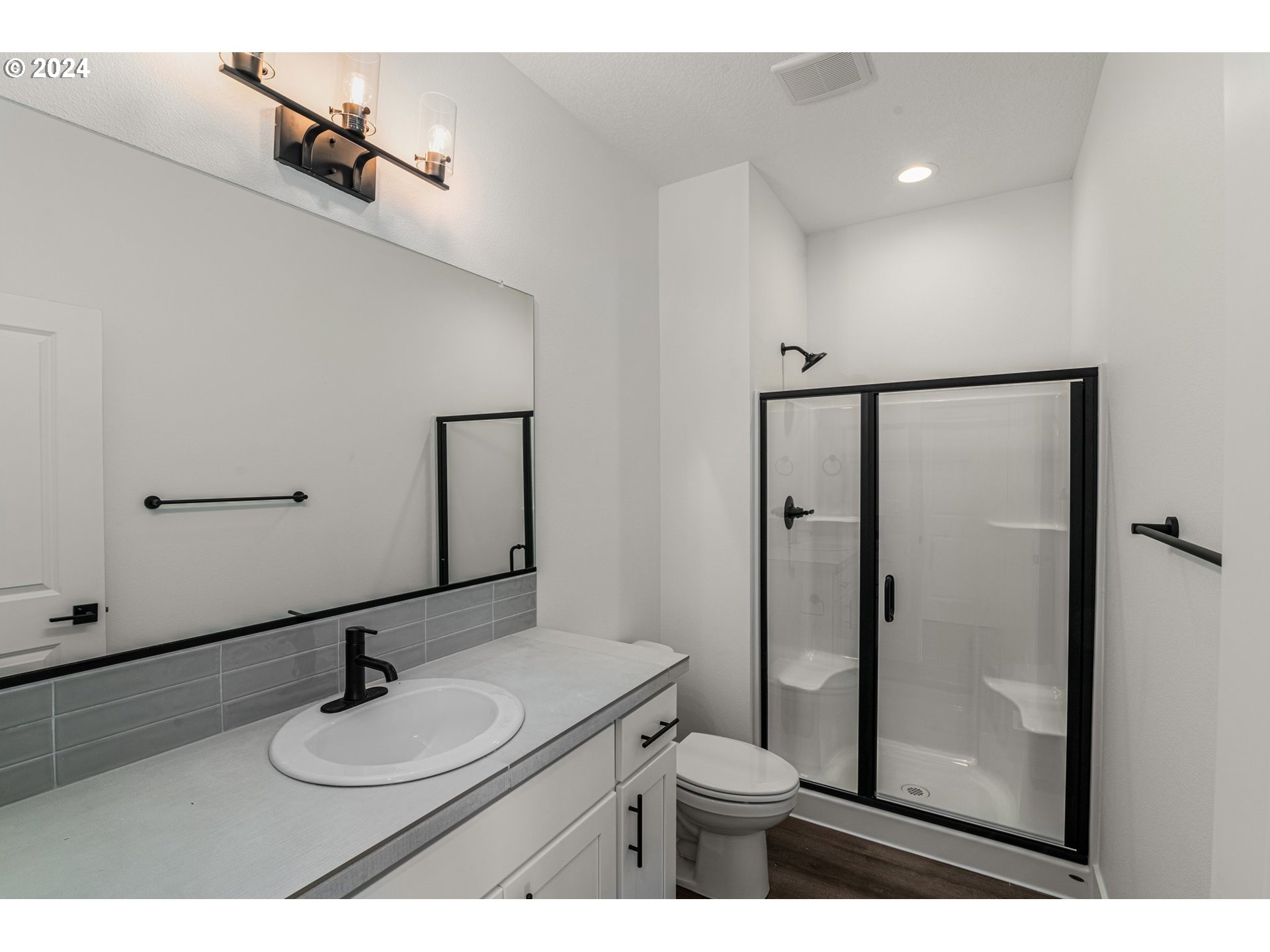 7939 Southwest 176th Terrace, Unit LOT1 Beaverton, OR 97007 - Photo 11 of 25 a bathroom with a sink a toilet and shower