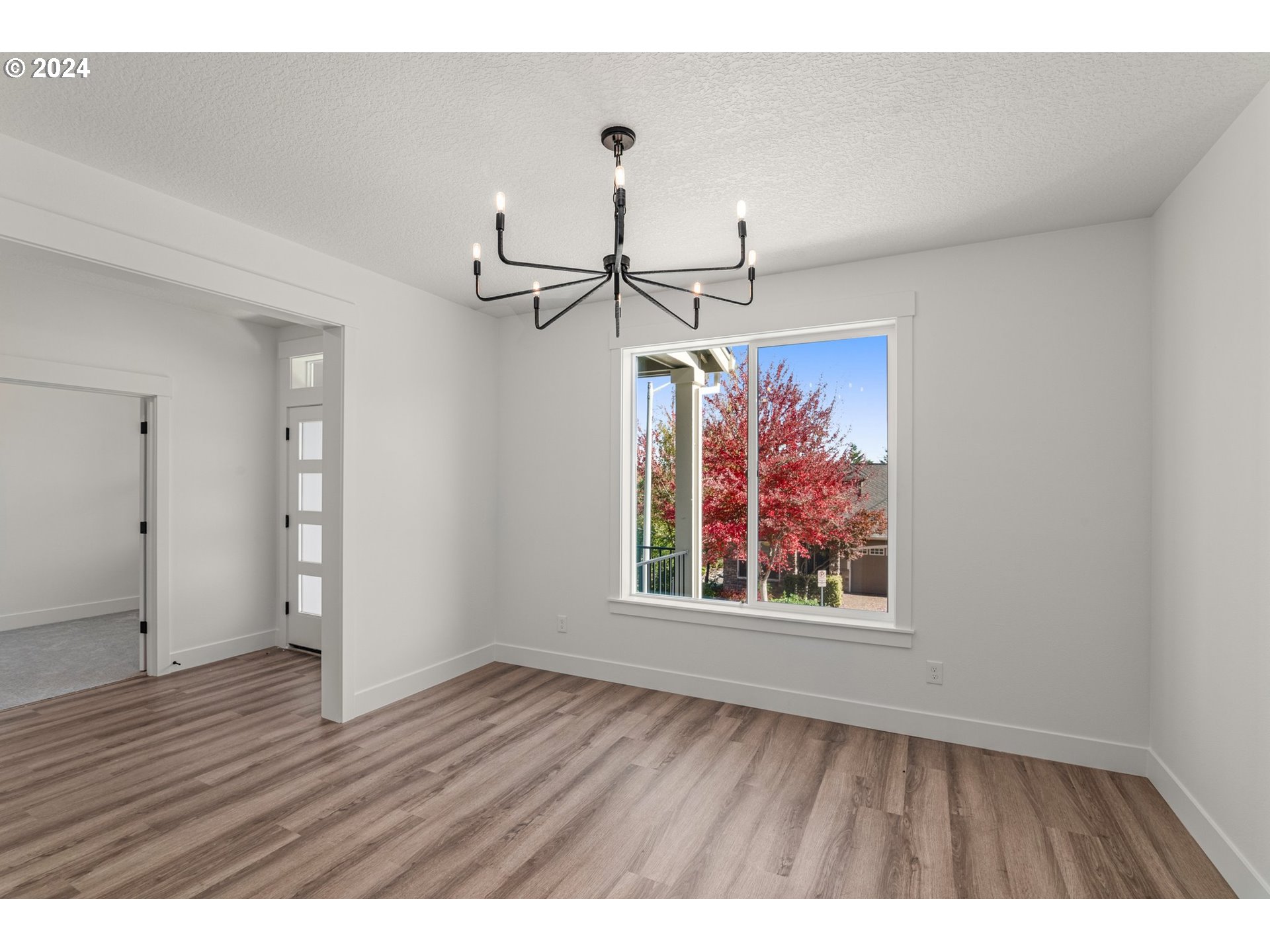 7939 Southwest 176th Terrace, Unit LOT1 Beaverton, OR 97007 - Photo 3 of 25 a view of a room with wooden floor chandelier and window