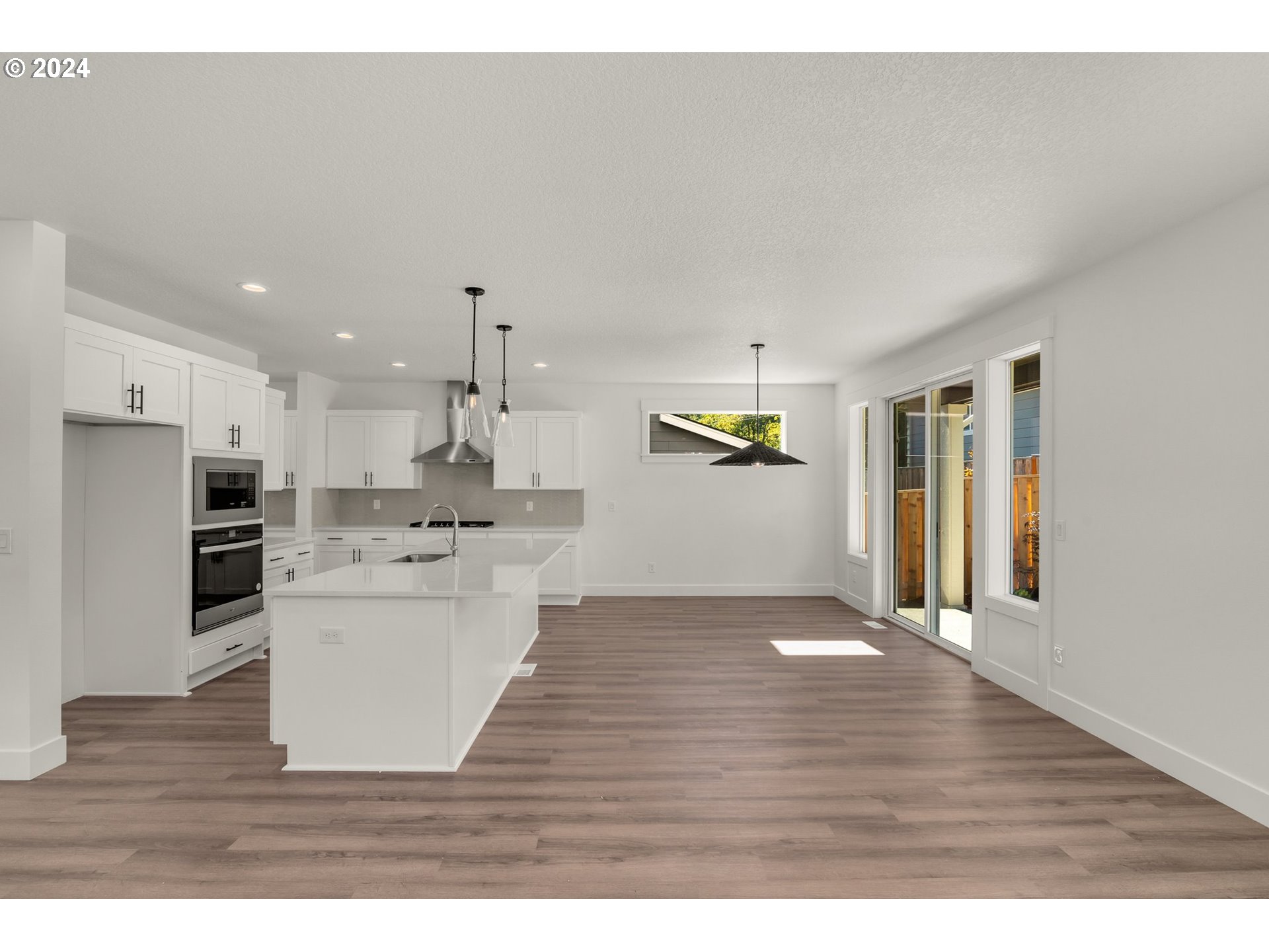 7939 Southwest 176th Terrace, Unit LOT1 Beaverton, OR 97007 - Photo 5 of 25 a kitchen with a refrigerator and a stove top oven