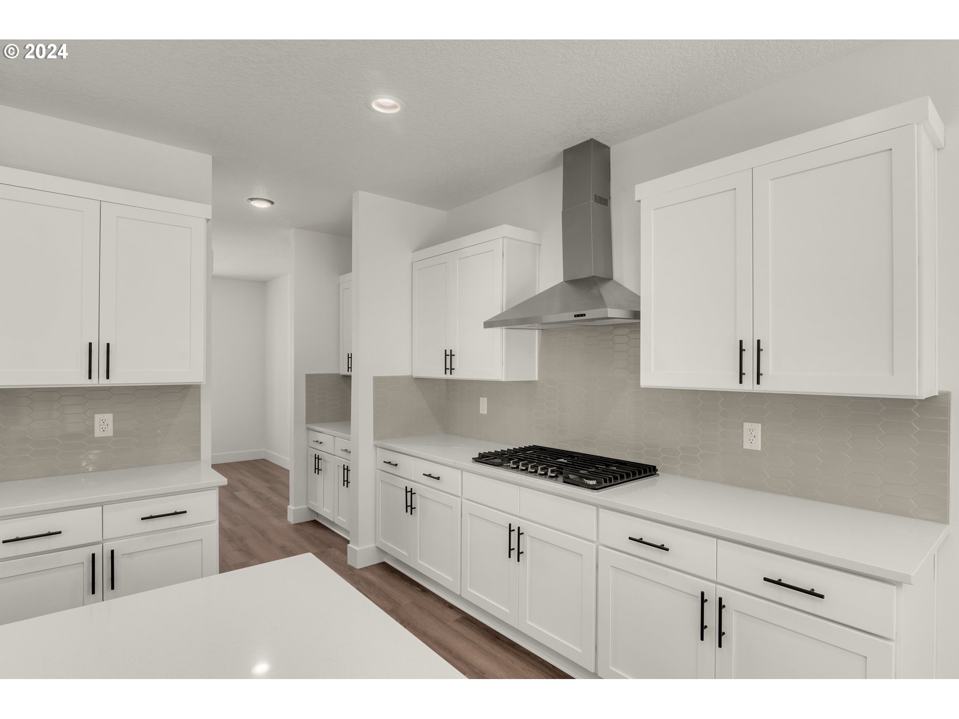 7939 Southwest 176th Terrace, Unit LOT1 Beaverton, OR 97007 - Photo 8 of 25 a kitchen with stainless steel appliances a sink a stove and cabinets
