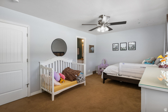 41 Benchmark Village Tooele, UT 84074 - Photo 15 of 26 Bedroom featuring dark colored carpet and a ceiling fan