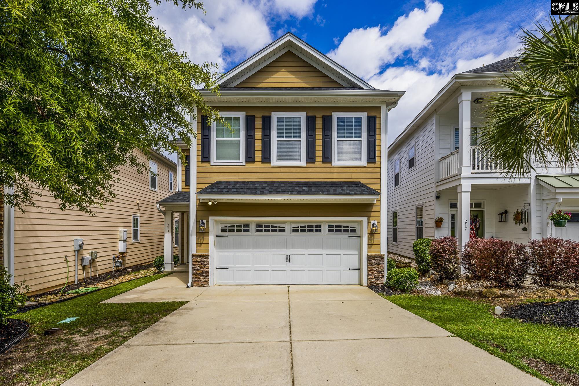 213 Sunset Point Drive Lexington, SC 29072 - Photo 1 of 35 a front view of a house with garden