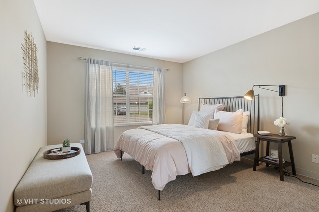 8 Sterling Circle, Unit 305 Wheaton, IL 60189 - Photo 14 of 36 a bedroom with bed and a window