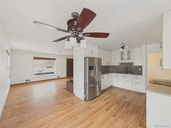 a kitchen with stainless steel appliances a refrigerator and a stove top oven