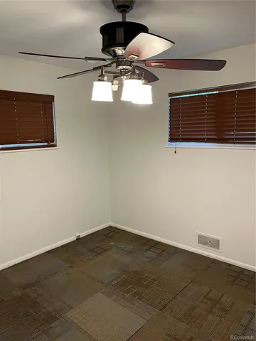 a view of a ceiling fan and a wooden floor
