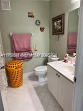 1250 Southeast 28th Court, Unit 206 Homestead, FL 33035 - Photo 13 of 26 a bathroom with a sink a toilet and mirror
