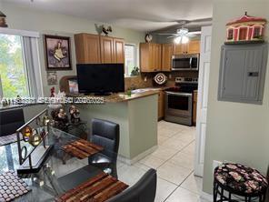 1250 Southeast 28th Court, Unit 206 Homestead, FL 33035 - Photo 2 of 26 a kitchen with stainless steel appliances a stove a sink and a refrigerator