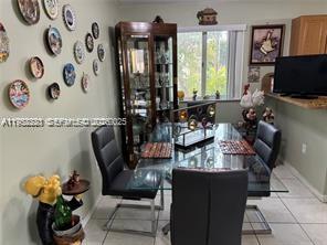 1250 Southeast 28th Court, Unit 206 Homestead, FL 33035 - Photo 4 of 26 a living room with furniture and a flat screen tv
