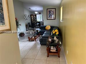 1250 Southeast 28th Court, Unit 206 Homestead, FL 33035 - Photo 5 of 26 a living room with furniture and wooden floor