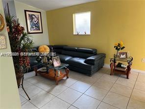 1250 Southeast 28th Court, Unit 206 Homestead, FL 33035 - Photo 6 of 26 a living room with furniture and a potted plant