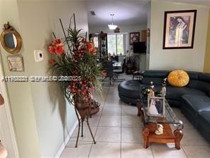 1250 Southeast 28th Court, Unit 206 Homestead, FL 33035 - Photo 8 of 26 a living room with furniture and flowers
