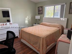 1250 Southeast 28th Court, Unit 206 Homestead, FL 33035 - Photo 10 of 26 a bed sitting in a bedroom next to a window