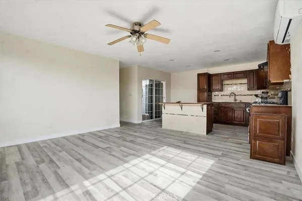 a large white kitchen with a stove a sink and a refrigerator