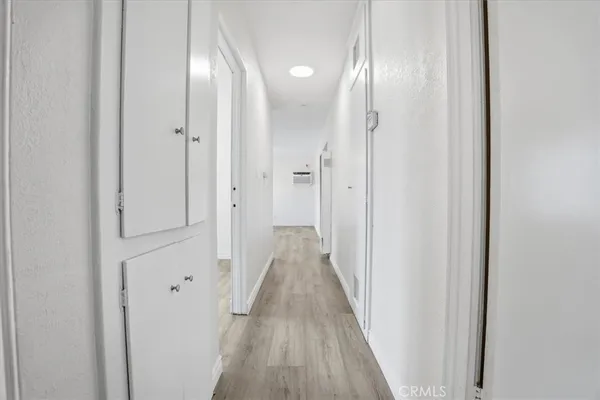 a view of a hallway with wooden floor