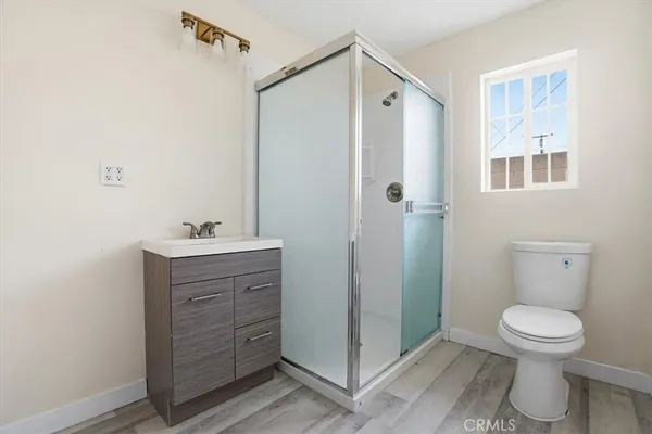 a bathroom with a toilet sink and shower